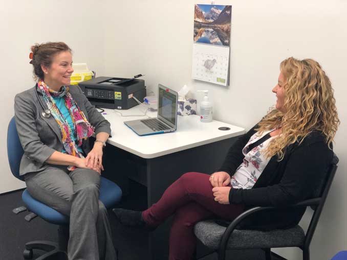 Dr. Jonie Girouard consulting with a patient in her clinic